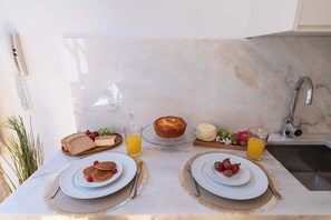 A breakfast setting with a marble countertop, a sink, and a telephone. - Modern Studio with Terrace & Jacuzzi by HostWise (Porto)