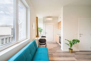 A modern apartment with a living area, dining space, and kitchen. - Antwerp Central City Apartment (Antwerp)
