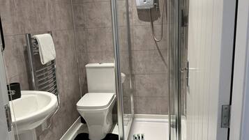 Shower, hair dryer, towels, toilet paper