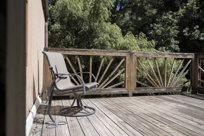 A wooden deck with a metal chair and a metal railing. - Winchester KS Farmhouse Near KC - 3BR Country Home (Winchester)