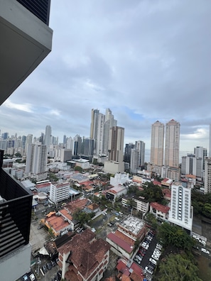 A cityscape with high-rise buildings, a mix of residential and commercial structures, and a clear sky. - Modern 1BR w/ Sea View | Prime Location at The Gray (Panamá)