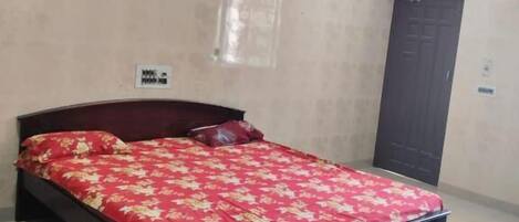 Quarto com cama, ventilador de teto e ar condicionado.