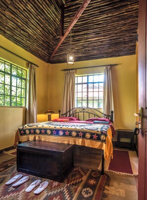 A room with a bed, a wooden chest, and a window with curtains. - 2BR Poolside Apartment in a quiet Jungle Oasis (Nairobi)