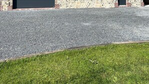 A two-story house with a garage, stone foundation, and a sloped roof. - Le pressoir, calm and nature - 5min Honfleur (Équemauville)