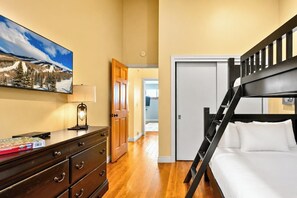 A bedroom with a bunk bed, wooden dresser, and a painting of a snowy landscape. - Spacious 3-Bedroom Townhome in the Prospector Neighborhood w/ Private Hot Tub! CCT-2180 by KBM (Park City)