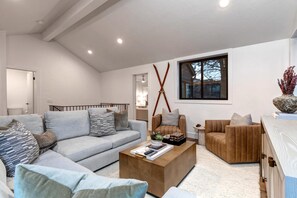 A modern living room with a grey sofa, a brown armchair, and a wooden coffee table. - KBM Resorts | Hidden Creek | Bright and Airy, Near Canyons Cabriolet, Gas Fireplace, Private Hot Tub, Comm Summer Pool HCT-26c (Park City)