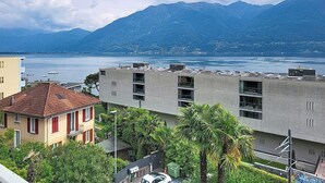 A residential area with buildings, a street, and a mountain in the background. - Casa Rivapiana by Interhome (Muralto)