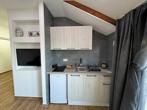 A compact kitchen with a refrigerator, a sink, and cabinets. - Authentic MNE stone villa with renovated apartments - 10 min to Lake Skadar (Virpazar)