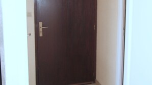 A closed dark wooden door with a light fixture above it. - Apartment “Soleil D'Oc 5” with Private Terrace and Wi-Fi (Cazaubon)
