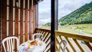 A wooden deck with a table set for breakfast, overlooking a mountainous landscape. - Functional Studio, Heart of the High Pyrenees (Garin)