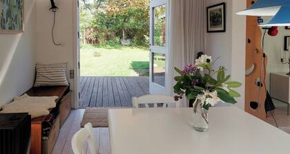 Cottage in woodland garden in natural harmony