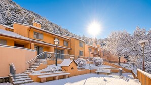 A snow-covered outdoor area with steps leading to a building, a bench, and a lamppost. - Peaceful Alpine Triplex Escape (Guillaumes)