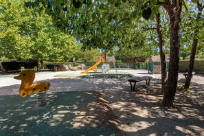 A playground with a slide, swings, and a climbing structure.