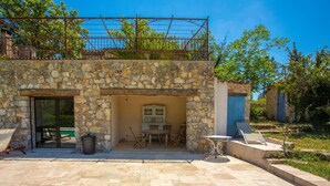 A stone building with a patio, outdoor seating, and a pool area. - Holiday Home 'Lou Mazet Du Gaudon' with Shared Pool, Shared Terrace and Shared Garden (Montauroux)