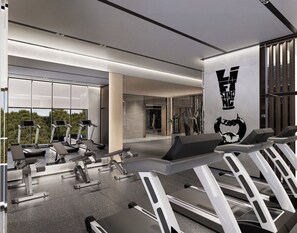 Un gimnasio moderno con cintas de correr, máquinas de pesas y un amplio ventanal con vistas al exterior.