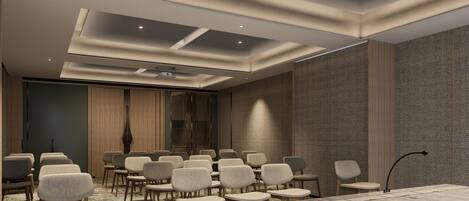 A conference room with a long table and multiple chairs, recessed ceiling lights, and patterned wall panels.