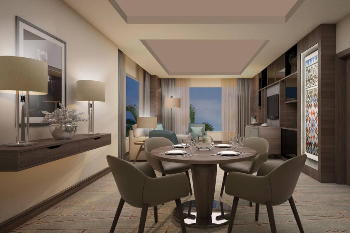 A modern dining room with a round table, six chairs, and a view of the outdoors.