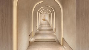 Un couloir bordé d’une série d’arches et doté d’une allée centrale.