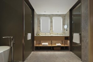 A modern bathroom with a walk-in shower, a double vanity with a mirror, and a towel rack. - Hilton Garden Inn Shijiazhuang High-Tech Zone (Shijiazhuang)