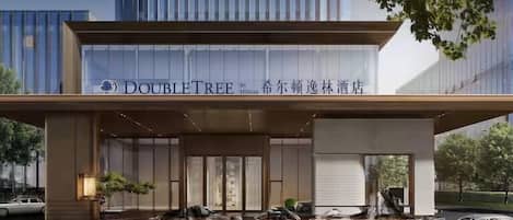 A hotel entrance with a sign for 'DOUBLETREE by Hilton' and a modern design.