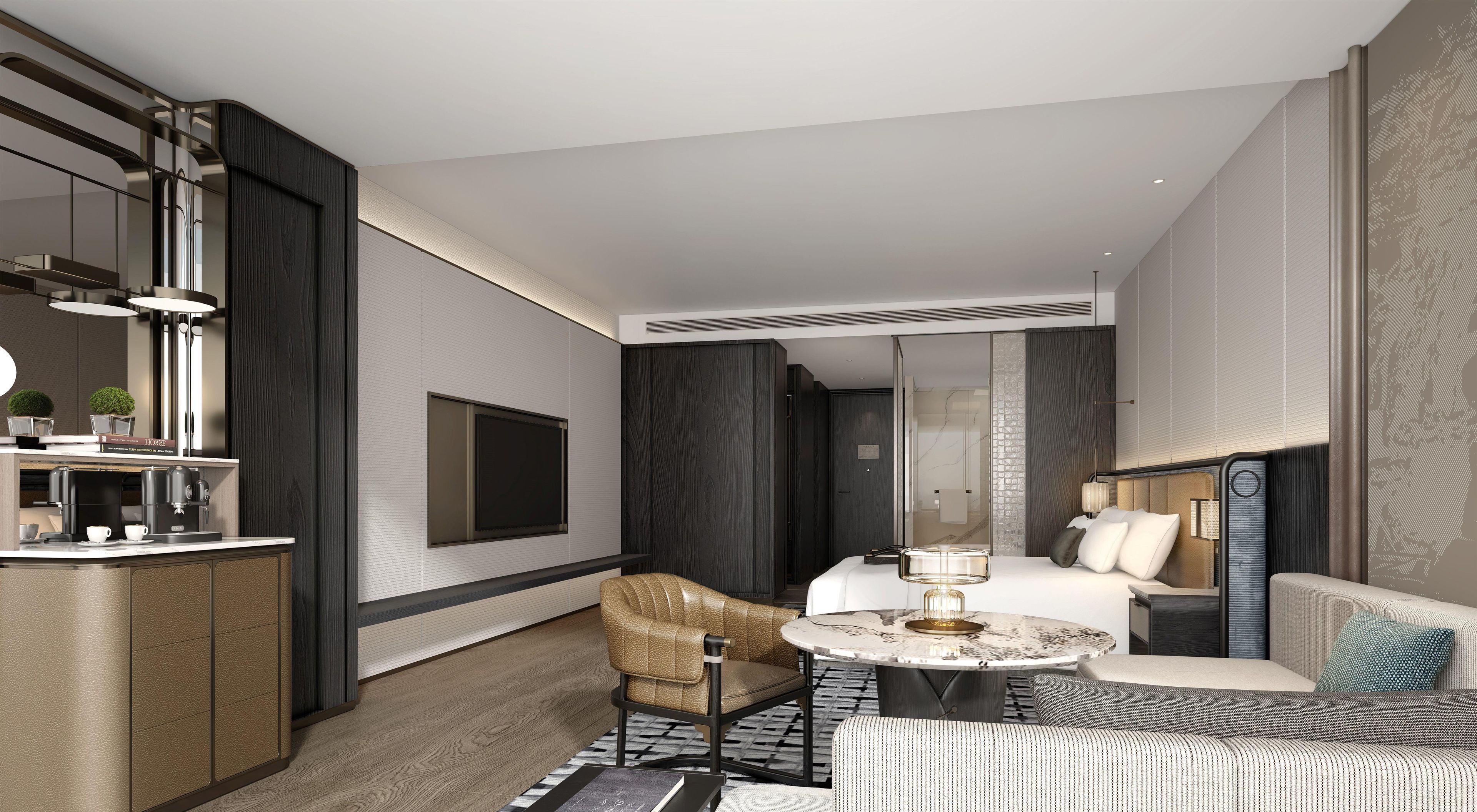 A modern hotel room with a kitchenette, a seating area with a sofa and armchair, a bed, and a large window.