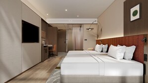 A modern hotel room with a large bed, a desk, and a shower area.
