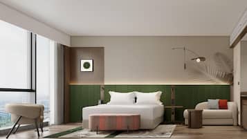 A modern hotel room with a large bed, a seating area, a view of the city, and a green accent wall.