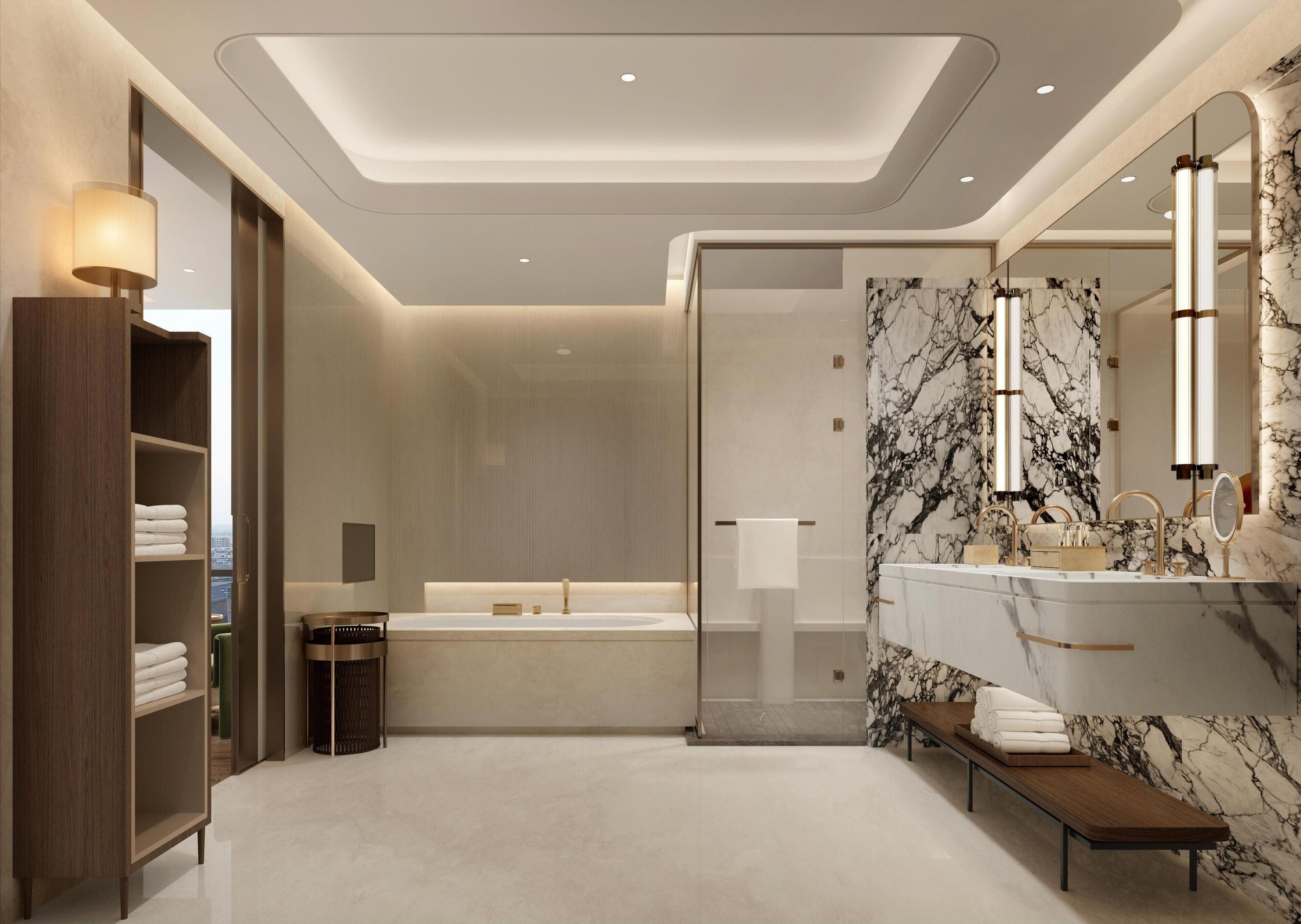 A modern bathroom with a bathtub, a vanity with a marble backsplash, and a large mirror.