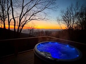 A hot tub with a view of a sunset and bare trees. - Luxury Cabin, Hot Tub, High Elevation, Panoramic Views, 3 Bedroom, Maggie Valley (Maggie Valley)
