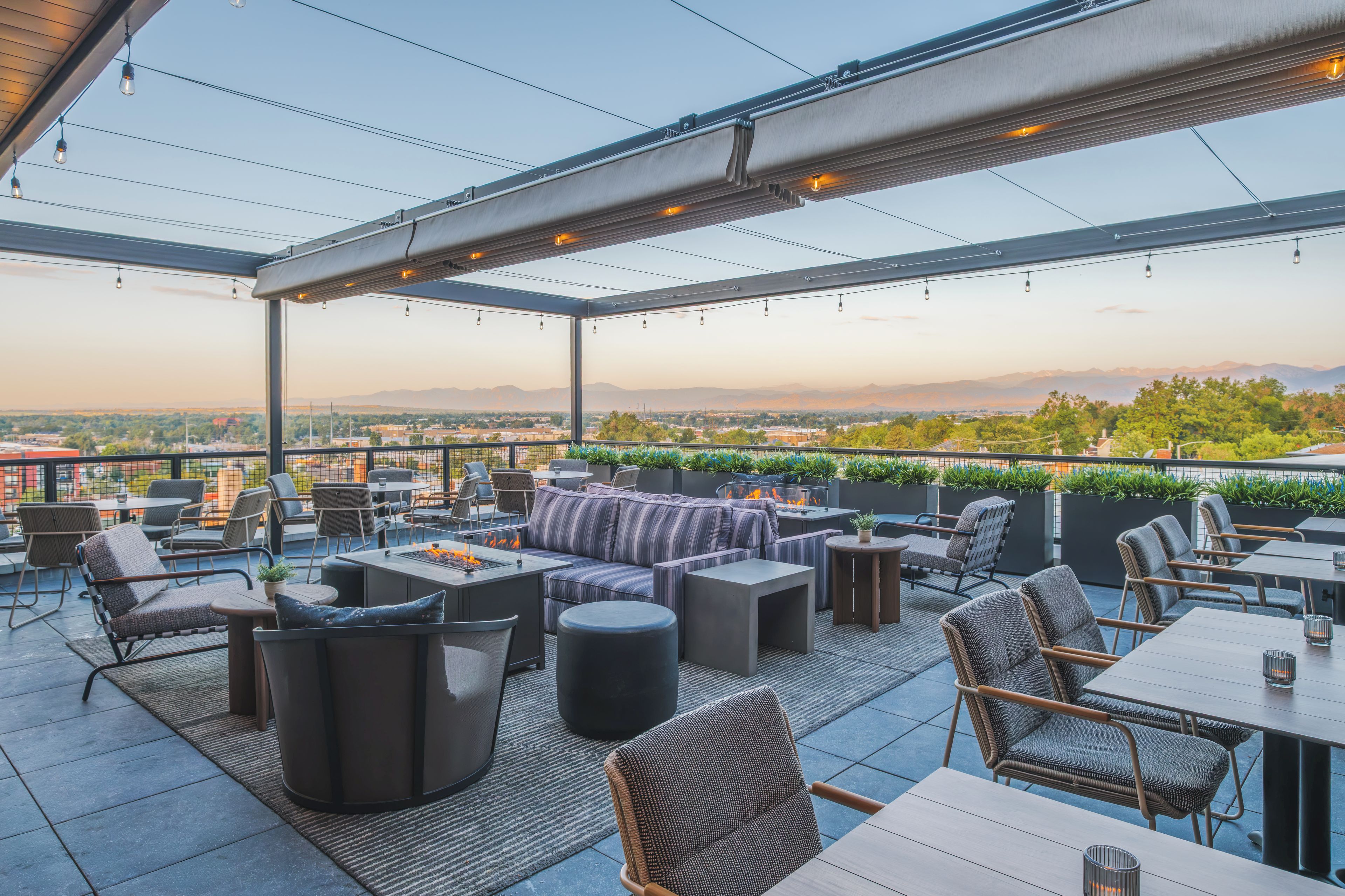 An outdoor patio area with seating, tables, and a fire feature.