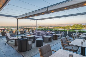 An outdoor patio area with seating, tables, and a fire feature.