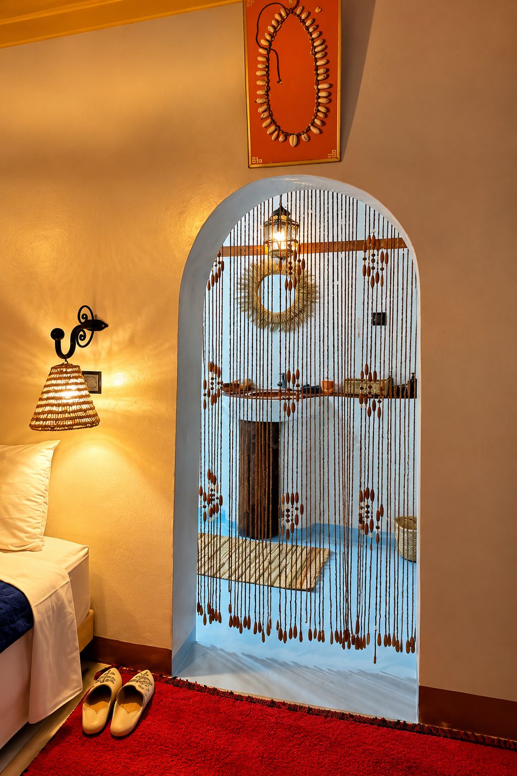 A room with a bed, a red carpet, a hanging lamp, and a decorative mirror.