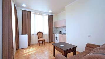 Deluxe Apartment, City View | Living area | 75-cm flat-screen TV with digital channels