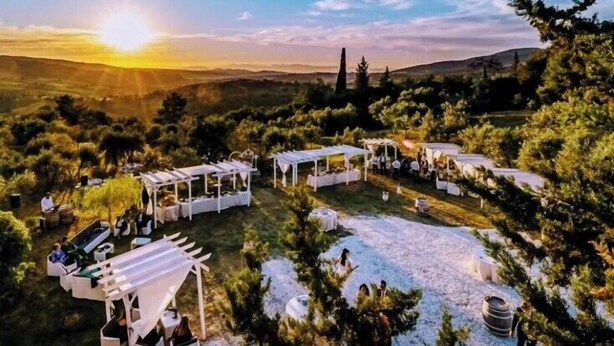 A scenic outdoor venue with multiple covered seating areas and a view of the surrounding landscape. - Azienda agricola la camporena  (Greve in Chianti)