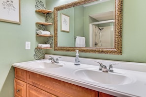 A bathroom with two sinks, a mirror with a leopard print frame, and a shower visible in the reflection. - 6 Mi to Downtown Vancouver: Peaceful Home w/ Deck (Vancouver)