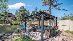 A covered patio with outdoor furniture, a pool, and a stone pathway. - Private Pickleball Court + Riverfront Bend Retreat (Bend)