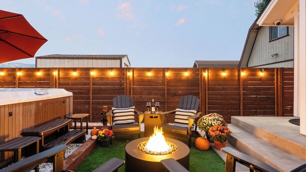 An outdoor patio with a fire pit, wooden deck, Adirondack chairs, and a barbecue grill. - Harvest Moon, EV charger, Hot Tub, Fire Pit (Big Bear)