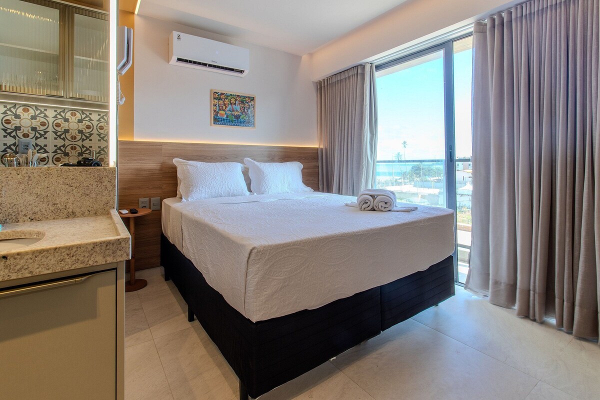Habitación de hotel con cama, baño y vistas de la ciudad.