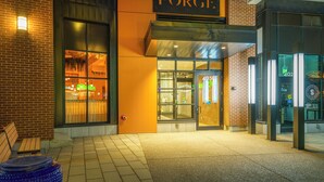 A building with a sign reading 'The Forge' and a large glass entrance.