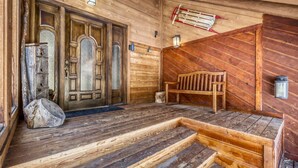 A wooden cabin interior with a front door, a bench, and a sled. - New Listing! Hot Tub, Sauna, Your Family Mountain Home Getaway! (Keystone)