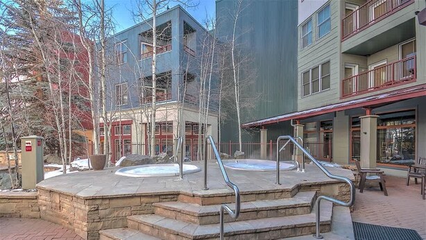A spa area with hot tubs and stone steps. - Heart of River Run Village! (Keystone)