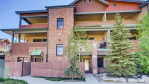 A multi-story residential building with a brick facade, balconies, and a gated entrance. - Amazing Heart of Frisco Condo (Frisco)