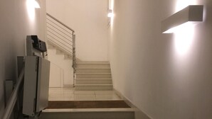 A staircase with handrails and wall-mounted lights. - Stradivari apartment in Venice historic center (Venezia)
