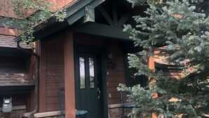 A wooden building with a green door and a small porch. - Family Hot Tub, Mountainscape Chalet! Paradise! (Breckenridge)
