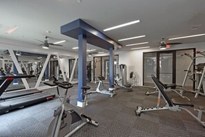 A gym with various exercise equipment, including treadmills and weight machines. - 5 mins to Broadway. Downtown. Midtown. Pool. Gym (Nashville)
