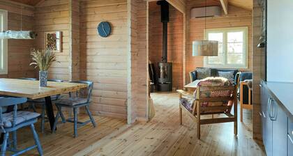 Red timber house with fjord view