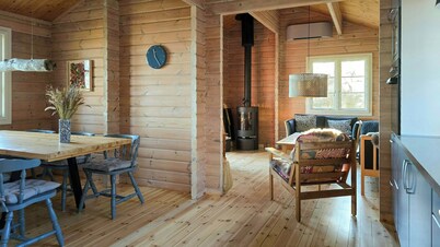 Red timber house with fjord view
