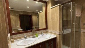 A bathroom with two sinks, a large mirror, and a glass-enclosed shower. - Paquita's House (Priego de Córdoba)