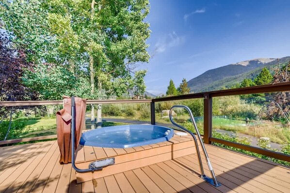 A hot tub on a wooden deck with a view of a forest and mountains. - Platinum Frost Fire, Hot Tub Access, Near Slopes! (Keystone)