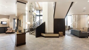 A spacious lobby with a staircase, seating area, and a television. - Park City 3BR Deluxe Villa – Fireplace, Full Kitchen, Balcony & Canyons Access (Park City)